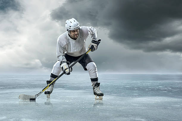 istock Ice hockey player on the ice in mountains 516858274