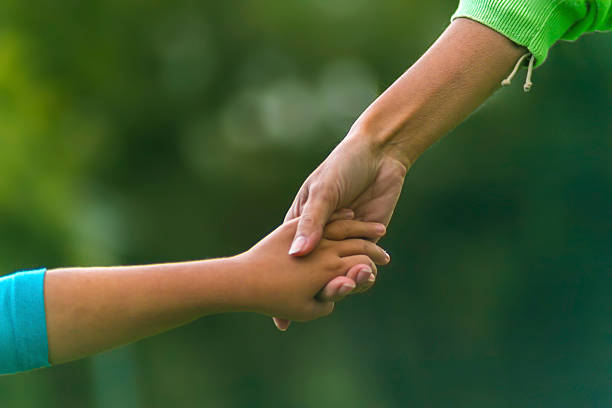istock Mom and daughter holding hands 516871817
