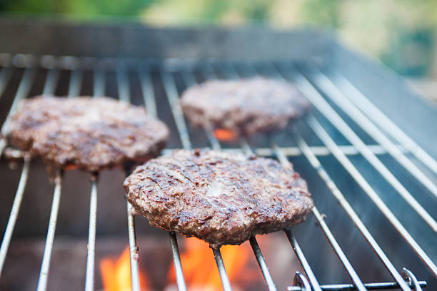 istock Burgers On A Firery Barbecue 516872835