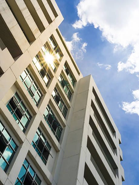 istock Office building with blue sky and starlight sun 516873077