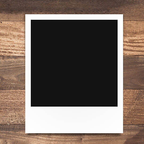 istock blank polaroid photo frame on brown wood plank background 516874169