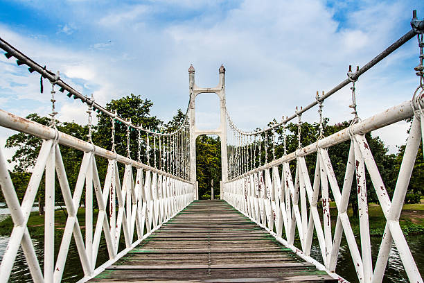 istock old white iron and wood hanging bridge 516874317
