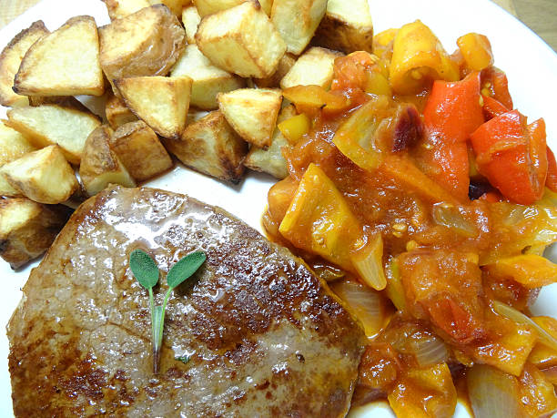 istock Griddled tenderloin steak with roasted potatoes / chunky chips, tomato ratatouille 516875005