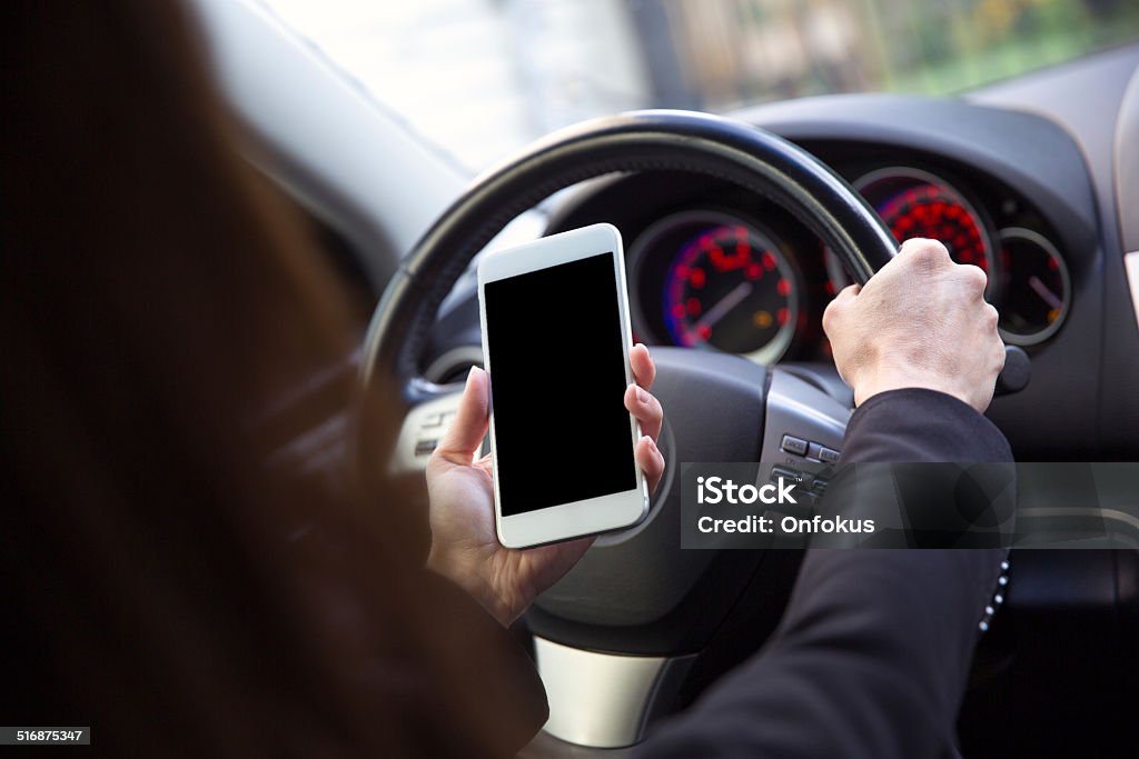 Woman Using Mobile Phone While Driving a Car Adult Stock Photo