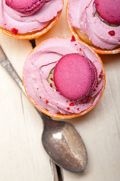 istock pink berry cream cupcake with macaroon on top 516886784