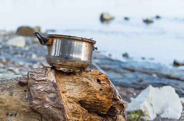 istock Left dirty pot on the river bank 516887672