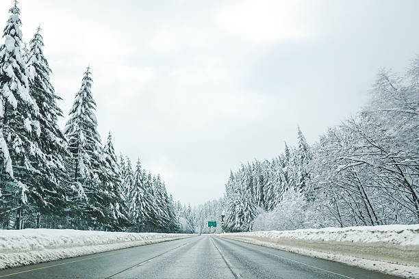 istock Empty road with high snow level covered landscape in winter 516888786