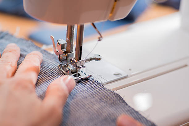 istock woman sews on the sewing machine 516889762