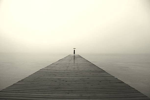 istock woman with black umbrella looking infinity in a surreal place 516890750