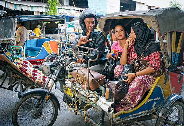 Medan, Indonesia - August 11, 2011: Auto rickshaw taxi in Medan, Indonesia. These taxis are popular type of transport among locals and tourists.