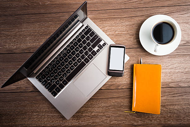 istock Office desk with laptop computer, planner, mobile smartphone and 516894010