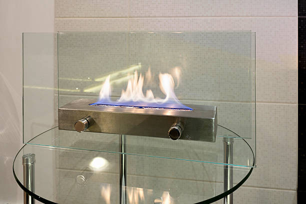 istock Portable glass fireplace on a glass table 516894114