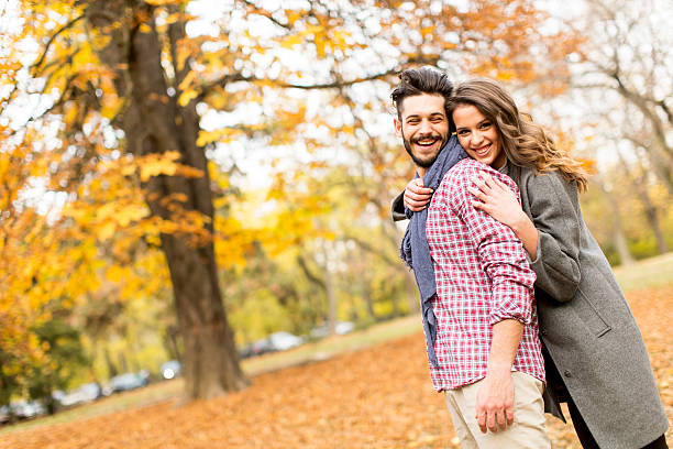 istock Young couple in the autumn park 516894448