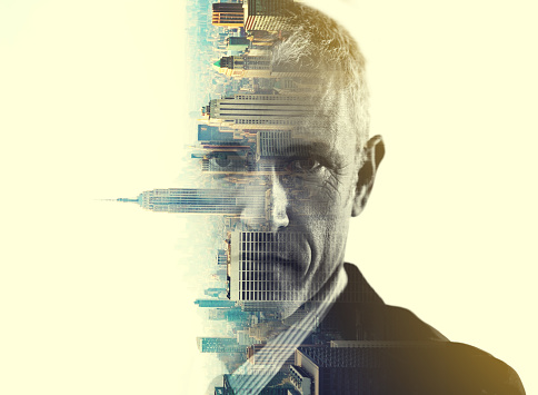 Multiple exposure portrait of a corporate businessman superimposed over a city background