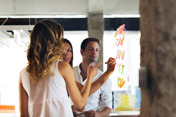 istock Business people looking at sticky notes and writing. 516895554