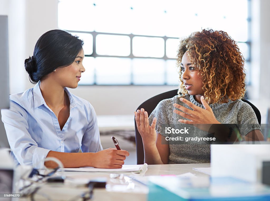 Their project's off to a good start Shot of two colleagues having a discussion in an office Discussion Stock Photo