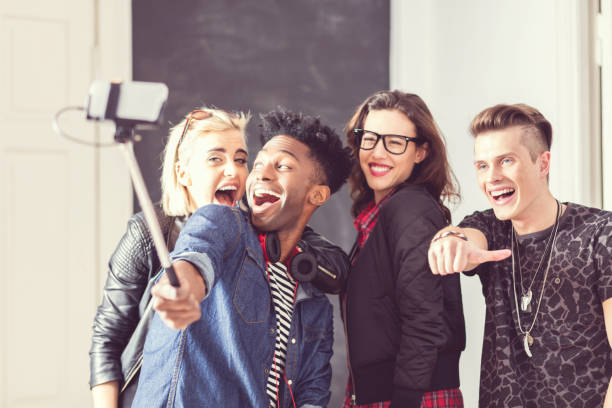istock Friends taking selfie using smart phone and selfie stick 516897172