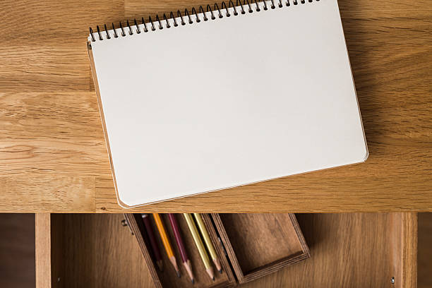 istock Blank notebook with pencils on the desk. Overhead 516899216