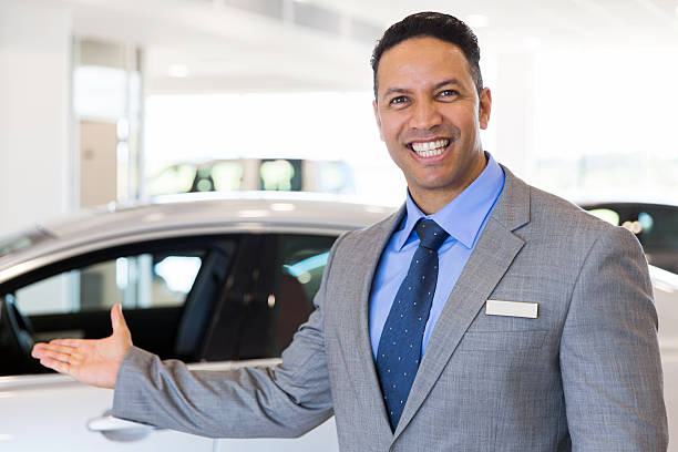 istock car salesman welcoming gesture 516899544