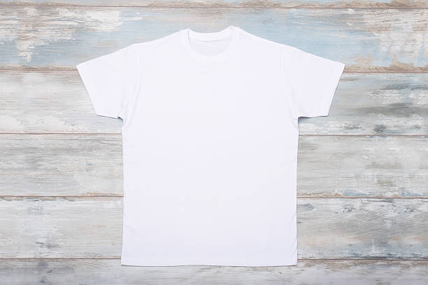 istock White t-shirt on wooden floor 516900224