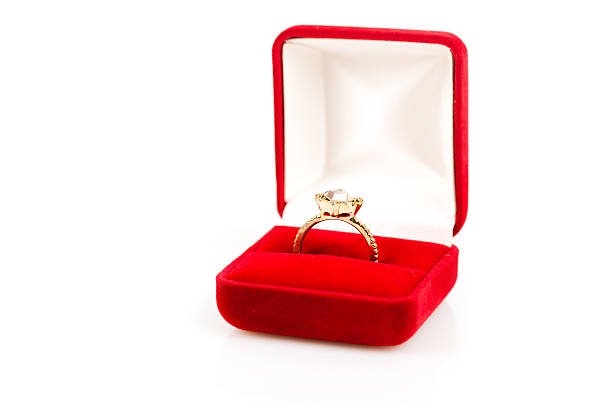 wedding rings in a gift box on white background stock photo