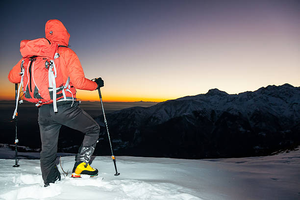 istock Winter hiking: man stands on a snowy ridge 516910351