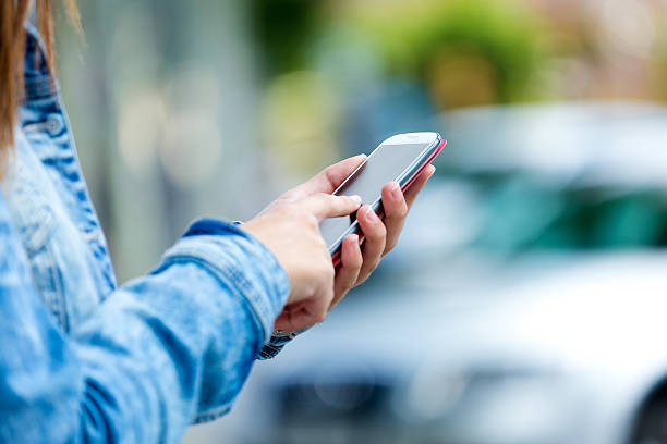 istock Mobile phone in a woman's hand. Outdoor image. 516911309
