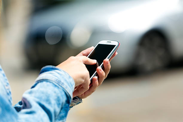 istock Mobile phone in a woman's hand. Outdoor image. 516911315