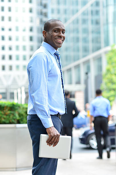 istock Smiling man standing outside offices building 516911973