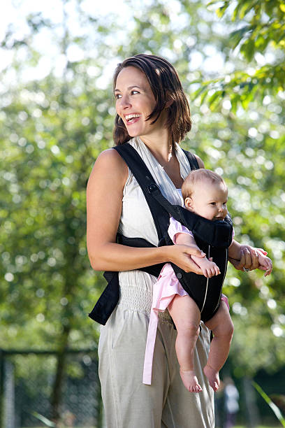 istock Cheerful mother with baby in sling 516912457