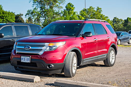 Hamilton, Canada - July 24, 2014: A red colored Ford Explorer SUV parked in a parking lot.