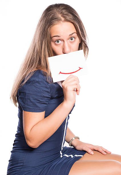 istock Young woman holding white board on white isolated background 516915957