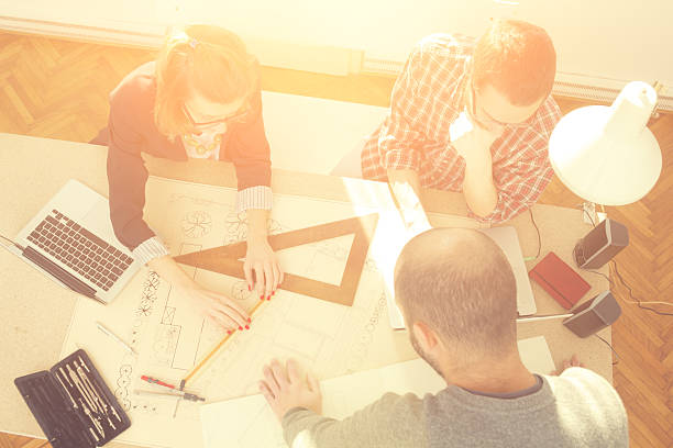 istock Young group of people/architects discussing business plans 516918920