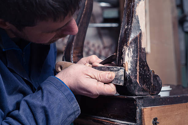 Carpenter restoring Wooden Furniture with plaster and putty Knif Portrait of Carpenter restoring Wooden Furniture with plaster and putty Knife in his workshop. knif stock pictures, royalty-free photos & images