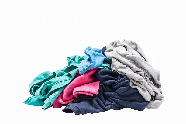 istock pile of dirty laundry Isolated on white. 516920276