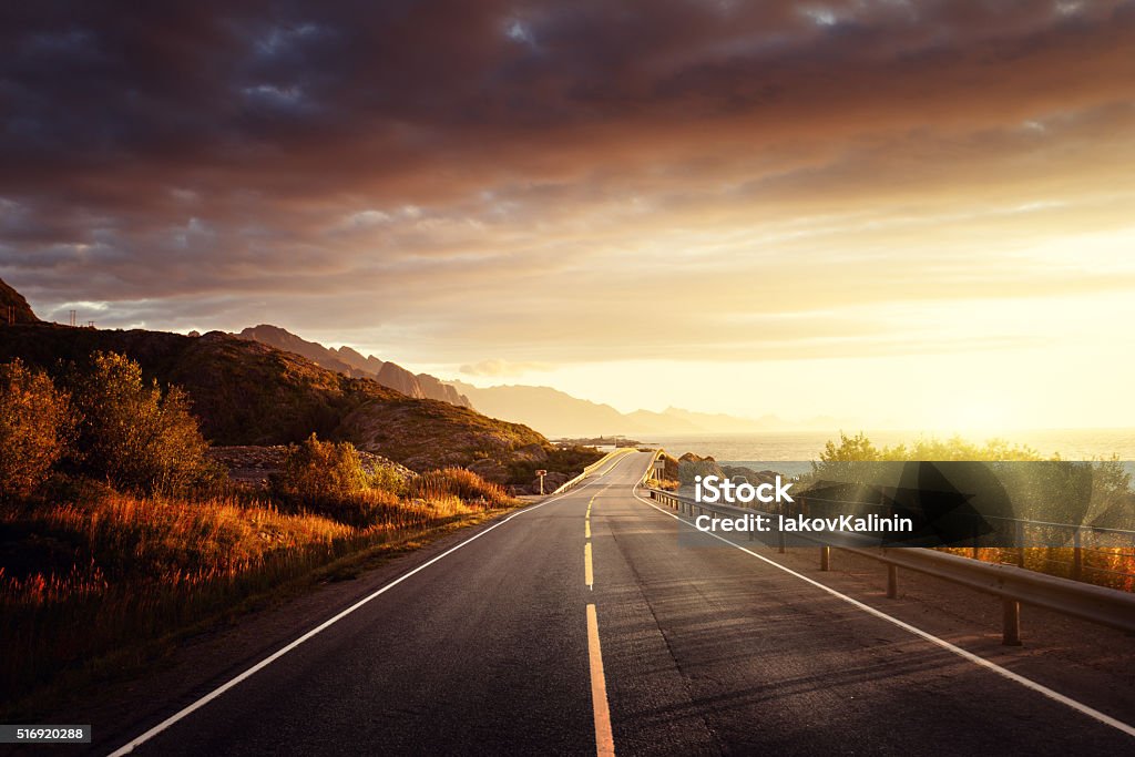 road by the sea in sunrise time,  Lofoten island, Norway Road Stock Photo