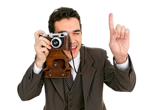 Photographer with an old film camera is going to make a shot, isolated on a white background. Retro style.