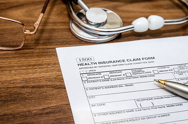 istock health insurance claim form and stethoscope 516922110