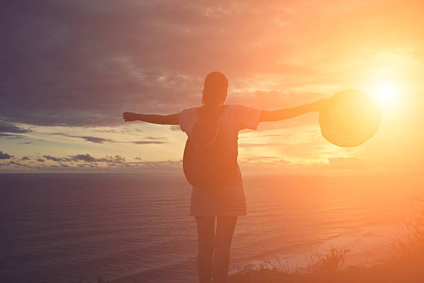 istock Silhouette of young girl with hat 516922828