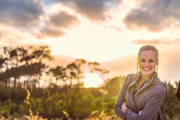 istock Smiling female hiker on mountain during sunset 516924868