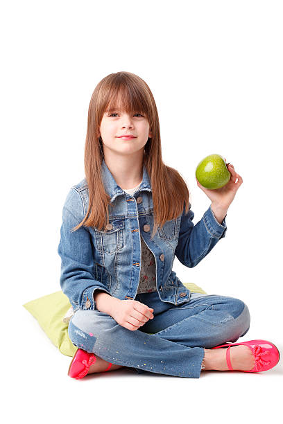 istock Cute girl with green apple 516925750