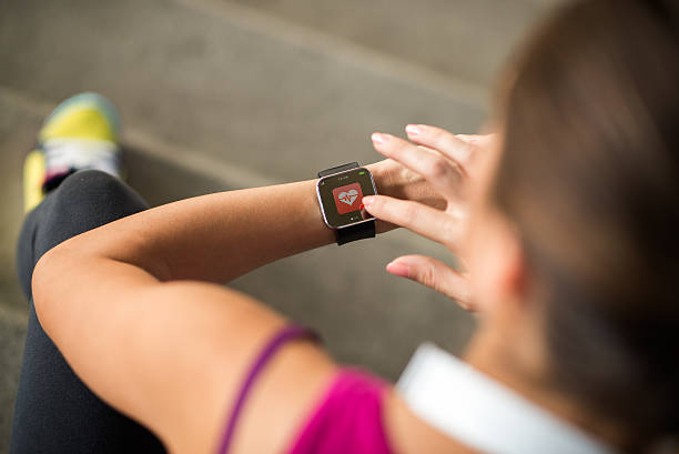 istock Female athlete operating smart watch 516927906