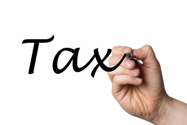 istock tax written by a hand 516928712