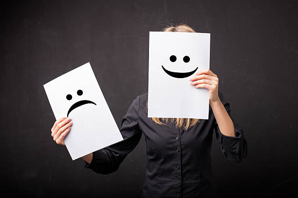 istock Woman changing smileys on her face 516929332