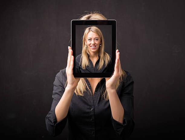 istock Woman holding tablet with her happy face 516929496