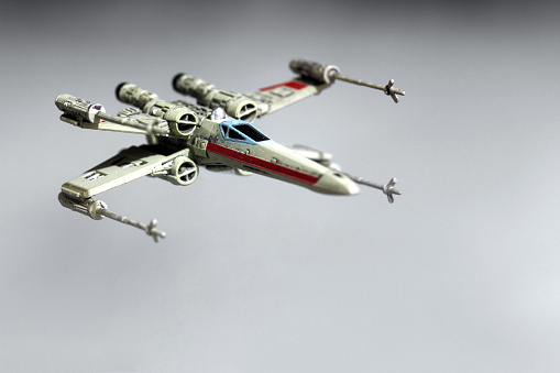 Vancouver, Canada - January 25, 2016: An X-Wing from the Star Wars film franchise against a misty background. The X-Wing is from the X-Wing Minatures game by Final Flight Games.