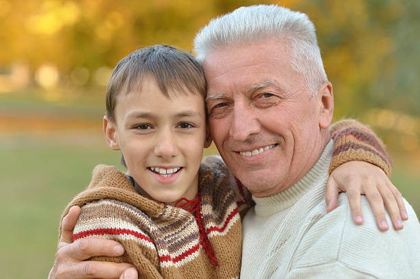istock Grandfather and grandson in park 516930772