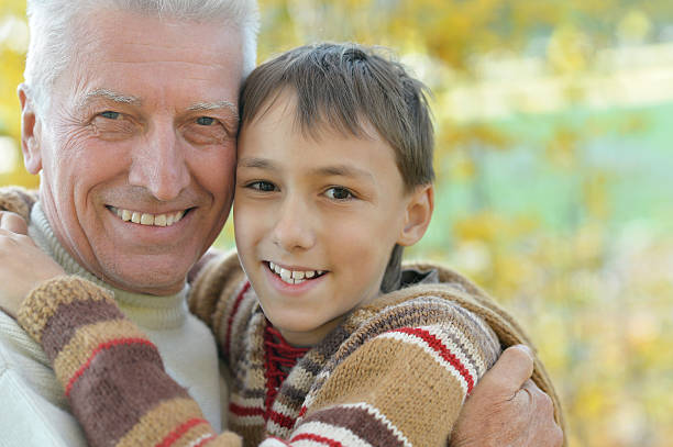 istock Grandfather and grandson in park 516931244