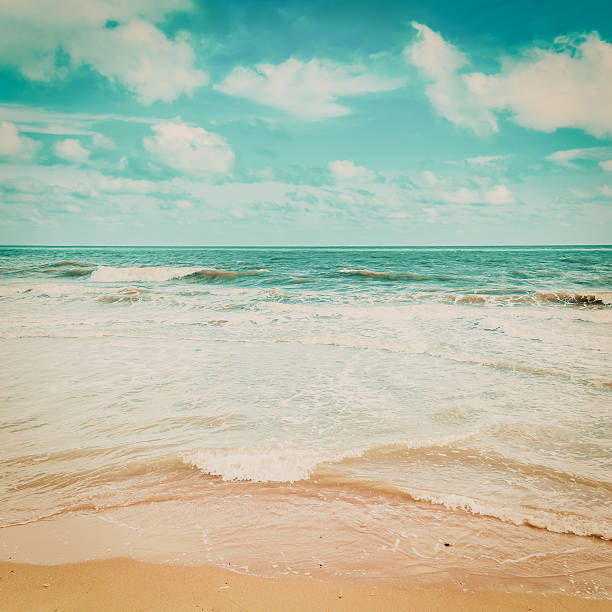 istock sea wave and beach with vintage tone. 516933794