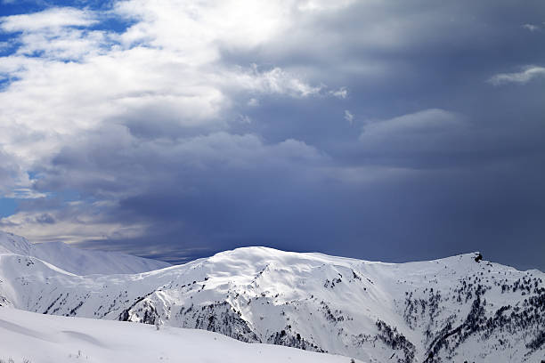 istock Sunlight slope and cloudy gray sky in evening 516934118
